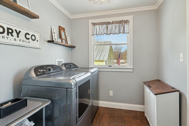 laundry area with washing machine and clothes dryer and ornamental molding