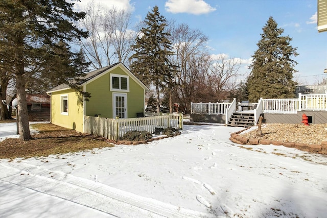 view of snow covered exterior with a wooden deck