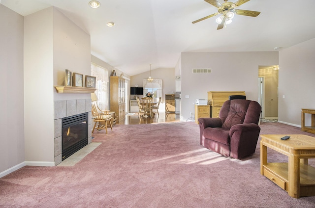 living room with carpet flooring, a fireplace, ceiling fan, and vaulted ceiling