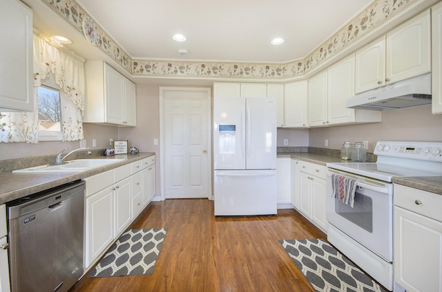 kitchen with white cabinetry, dark hardwood / wood-style floors, sink, and white appliances