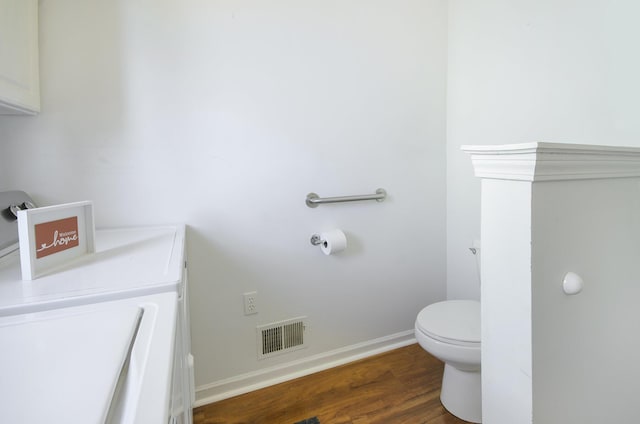 bathroom with wood-type flooring and toilet