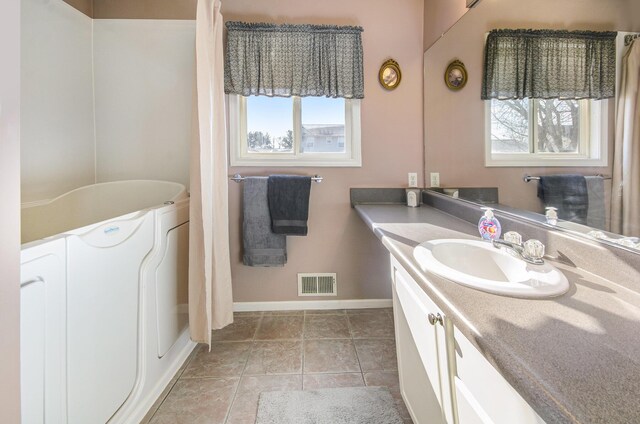 bathroom featuring vanity and washer / clothes dryer