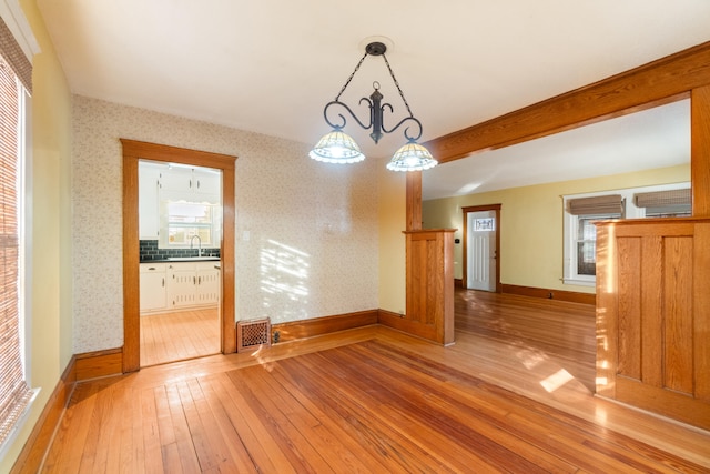 empty room with sink and light hardwood / wood-style flooring