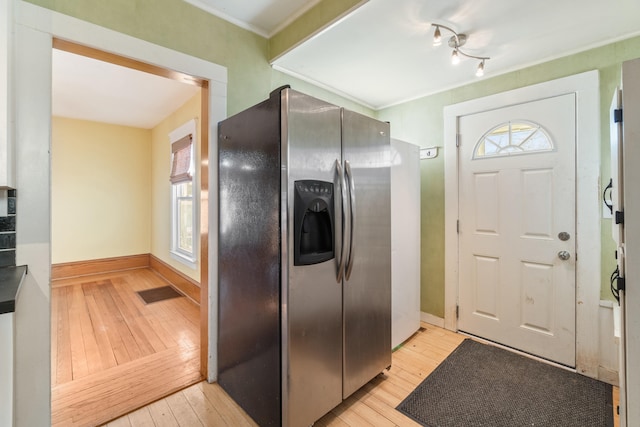 kitchen featuring stainless steel refrigerator with ice dispenser and light hardwood / wood-style floors