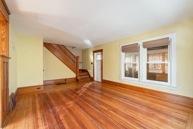 unfurnished living room featuring wood-type flooring