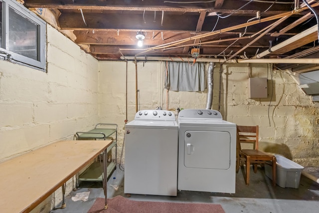 clothes washing area with washing machine and dryer