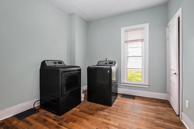 washroom featuring independent washer and dryer and dark hardwood / wood-style flooring