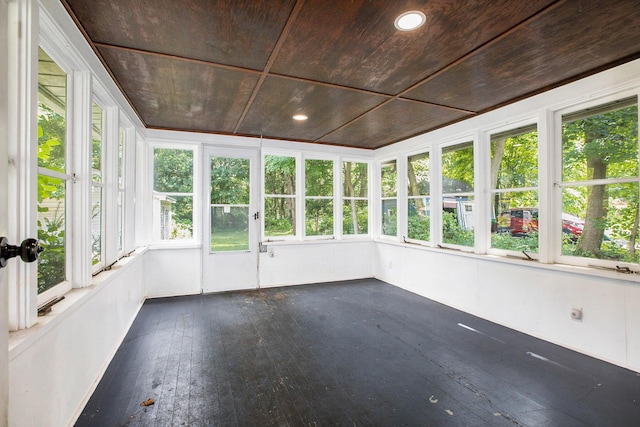 unfurnished sunroom with a healthy amount of sunlight and wood ceiling