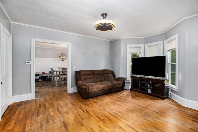 living room with hardwood / wood-style flooring and ornamental molding