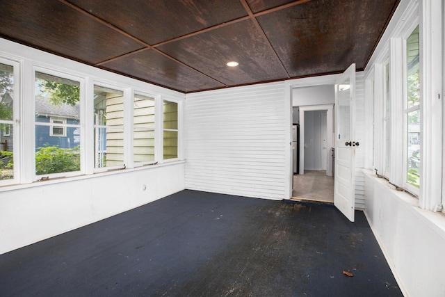 unfurnished sunroom with wooden ceiling