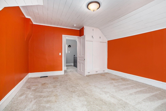 additional living space with vaulted ceiling, light carpet, and wood ceiling