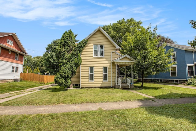 view of property featuring a front yard and covered porch