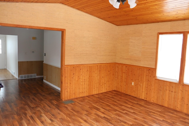 spare room with dark hardwood / wood-style flooring, wood ceiling, vaulted ceiling, and ceiling fan