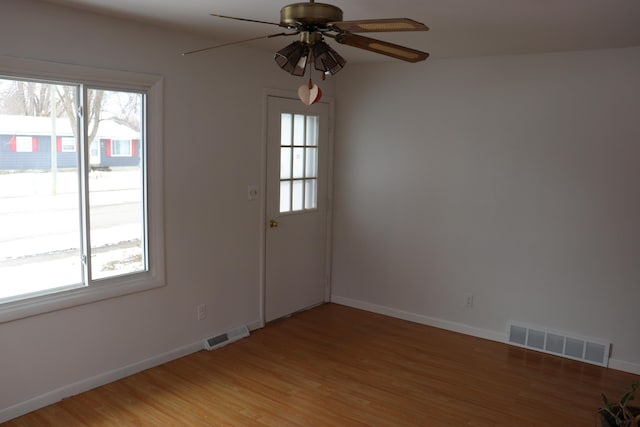 empty room with wood-type flooring and ceiling fan