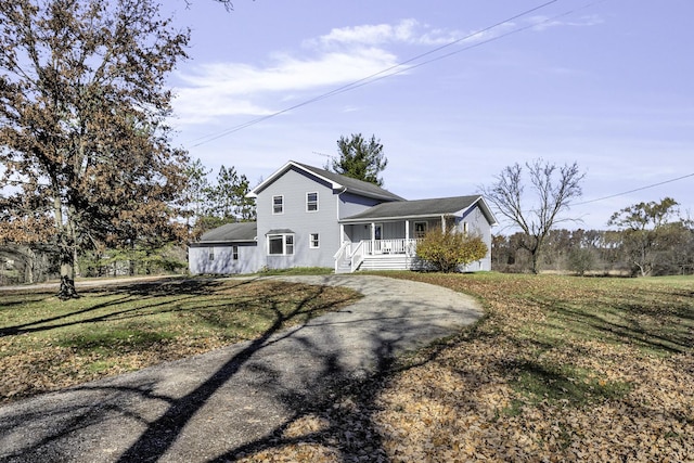 view of front of property with covered porch and a front yard