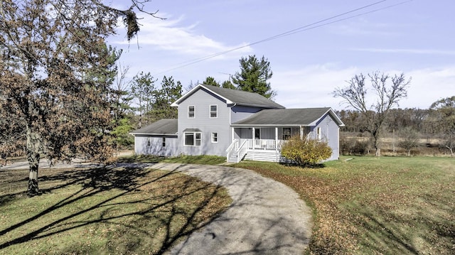 view of front of home featuring a front yard and covered porch