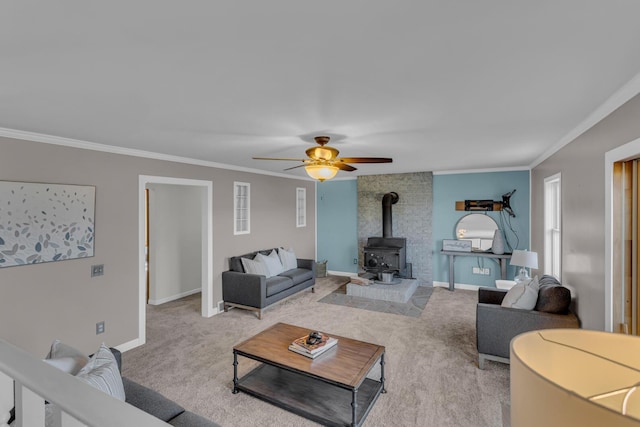 carpeted living room with crown molding, ceiling fan, and a wood stove