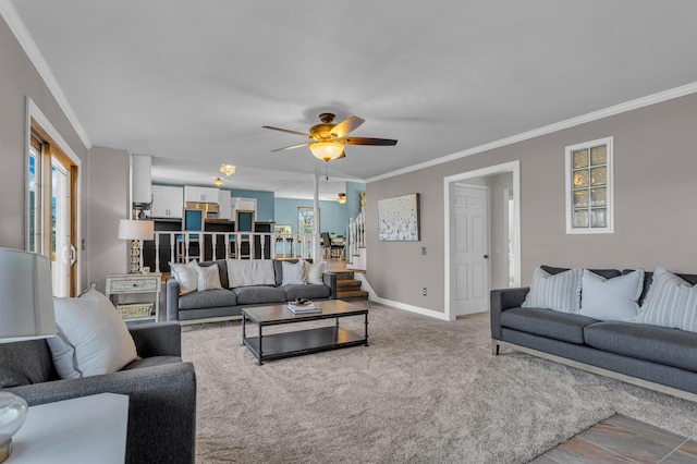 carpeted living room featuring crown molding, plenty of natural light, and ceiling fan