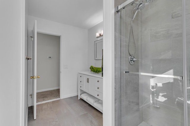 bathroom featuring vanity and a shower with door