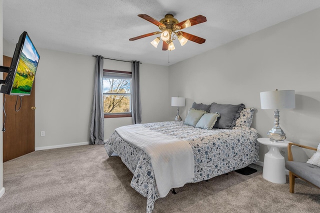 carpeted bedroom with a textured ceiling and ceiling fan