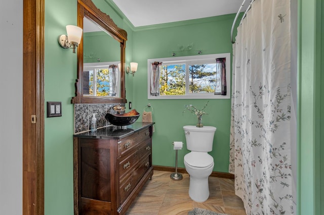 bathroom with vanity, curtained shower, ornamental molding, and toilet