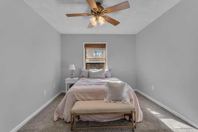 bedroom with carpet, a textured ceiling, and ceiling fan