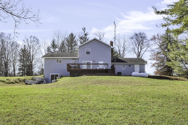 back of house featuring a deck and a lawn