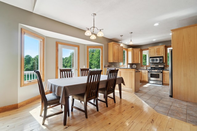 dining area with a chandelier and light hardwood / wood-style floors