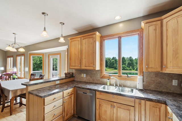 kitchen featuring kitchen peninsula, dishwasher, sink, and hanging light fixtures