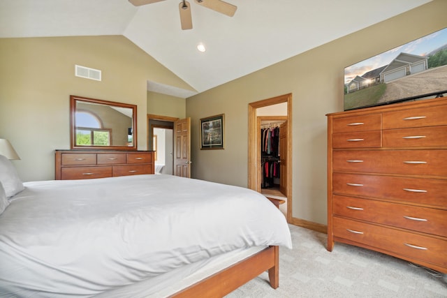 carpeted bedroom featuring vaulted ceiling, a spacious closet, ceiling fan, and a closet