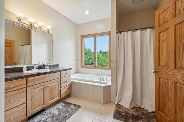 bathroom with vanity, tiled bath, and tile patterned floors