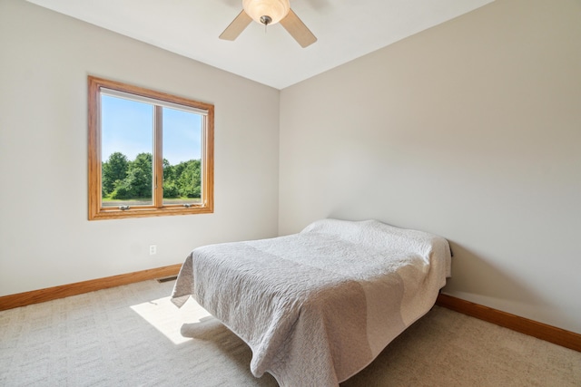 bedroom featuring ceiling fan and light colored carpet