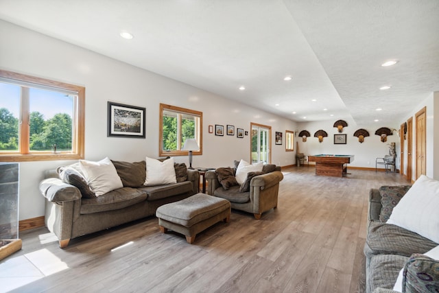 living room with pool table and light hardwood / wood-style flooring