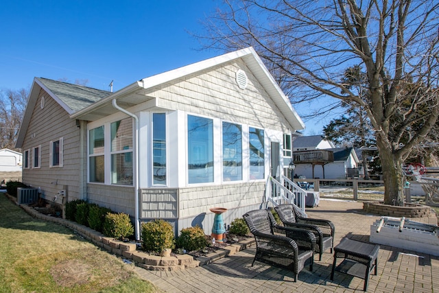 view of home's exterior with central AC unit and a patio area