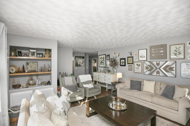 living room with light hardwood / wood-style flooring and a textured ceiling