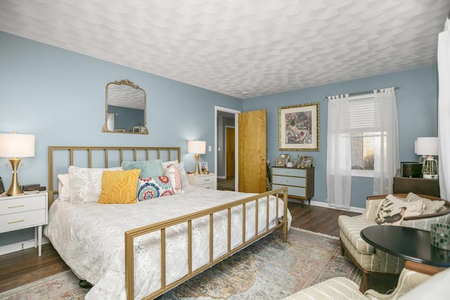 bedroom featuring dark hardwood / wood-style floors and a textured ceiling