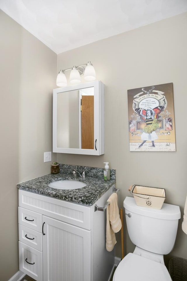 bathroom featuring vanity and toilet