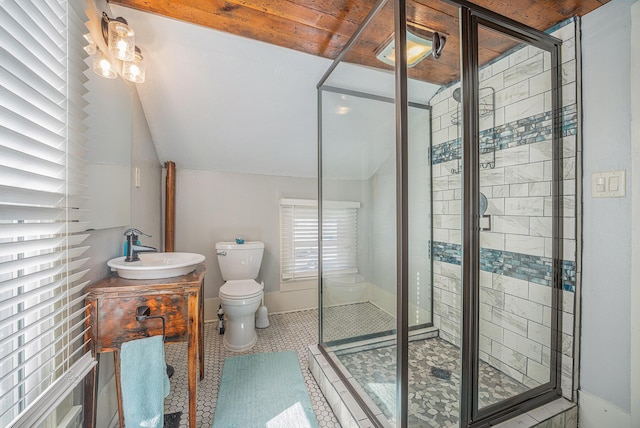 bathroom with tile patterned flooring, toilet, vanity, and a shower with shower door