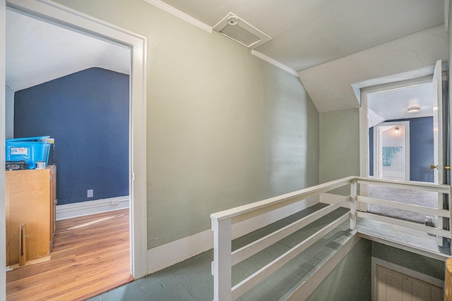 staircase with vaulted ceiling and wood-type flooring