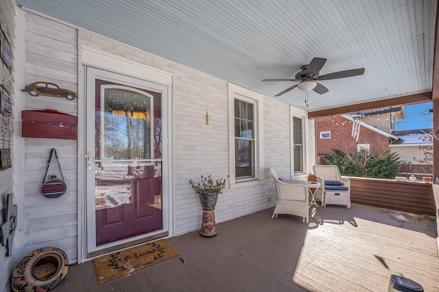 entrance to property featuring ceiling fan and covered porch