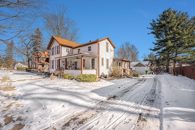 exterior space with an outbuilding, a garage, and covered porch