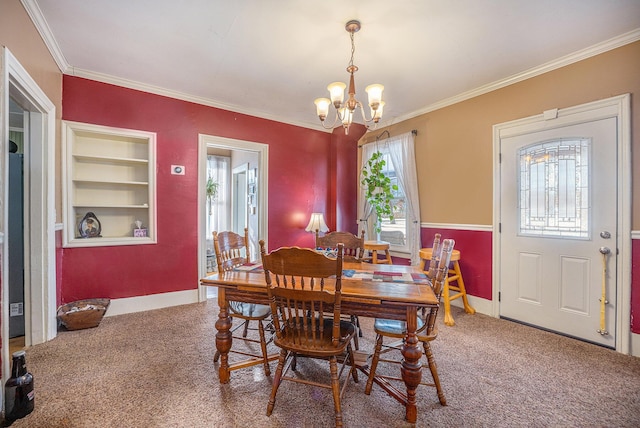 carpeted dining space featuring a notable chandelier, ornamental molding, and built in features