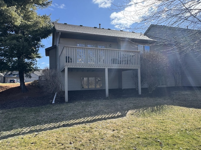 rear view of property featuring a deck and a lawn