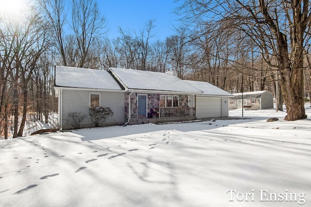 view of front of property featuring a garage and a porch