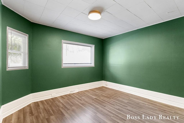 unfurnished room featuring hardwood / wood-style flooring