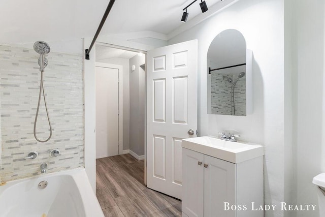 bathroom with vanity, tiled shower / bath combo, and hardwood / wood-style flooring