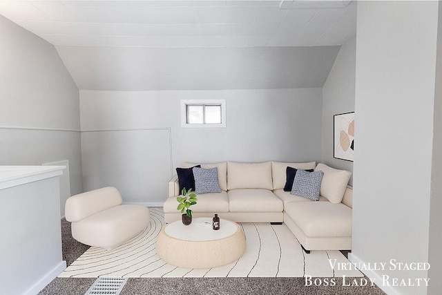 carpeted living room with vaulted ceiling