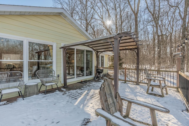 snow covered deck with a pergola