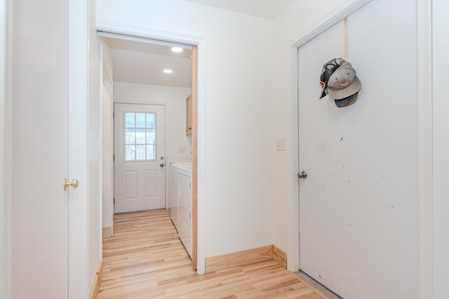 hall featuring light hardwood / wood-style floors and independent washer and dryer