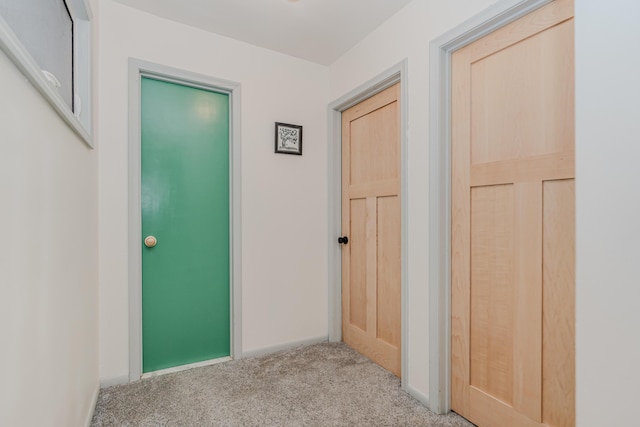 hall featuring light colored carpet